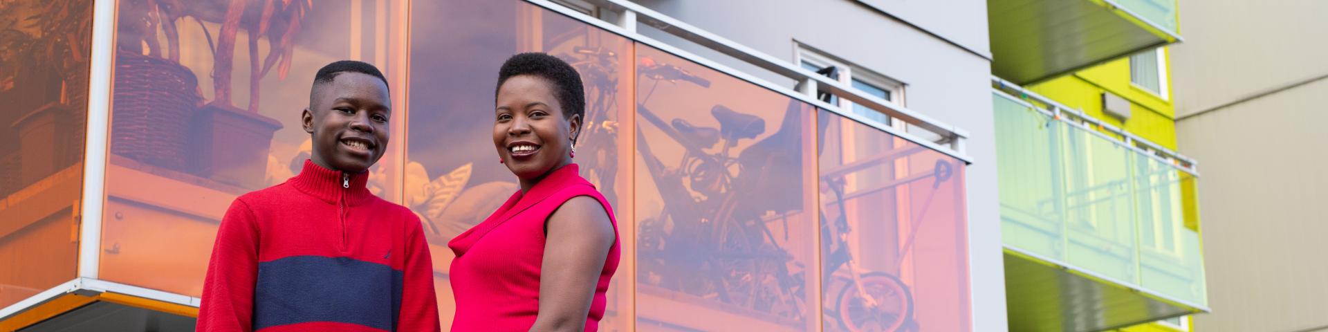 Mother and son in the courtyard at YWCA Housing Community, smiling. 