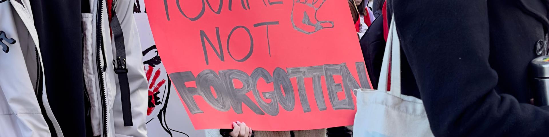 sign at a march saying "you are not forgotten"