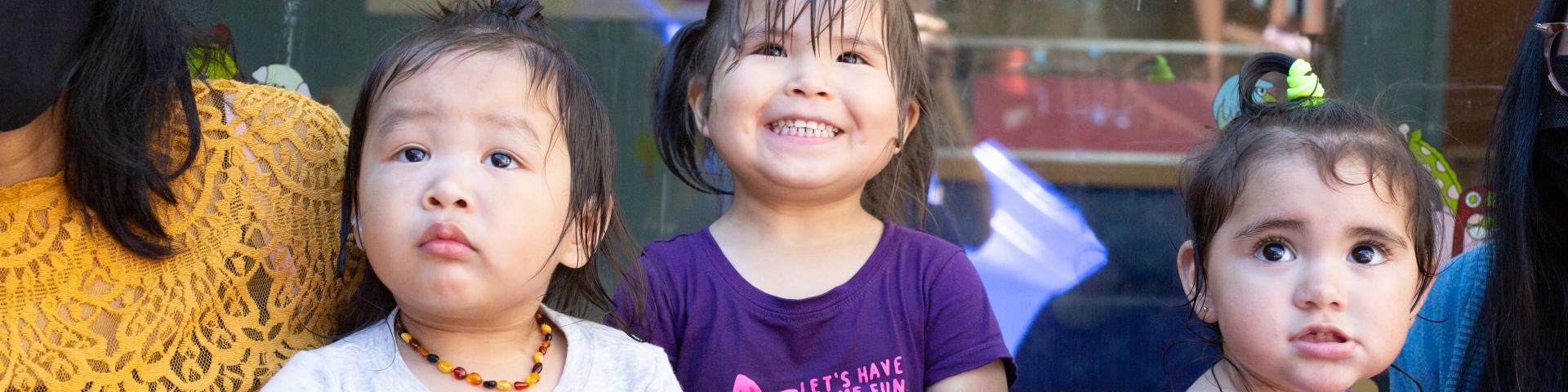 Children and care giver play at YWCA Crabtree Corner Child Care Centre