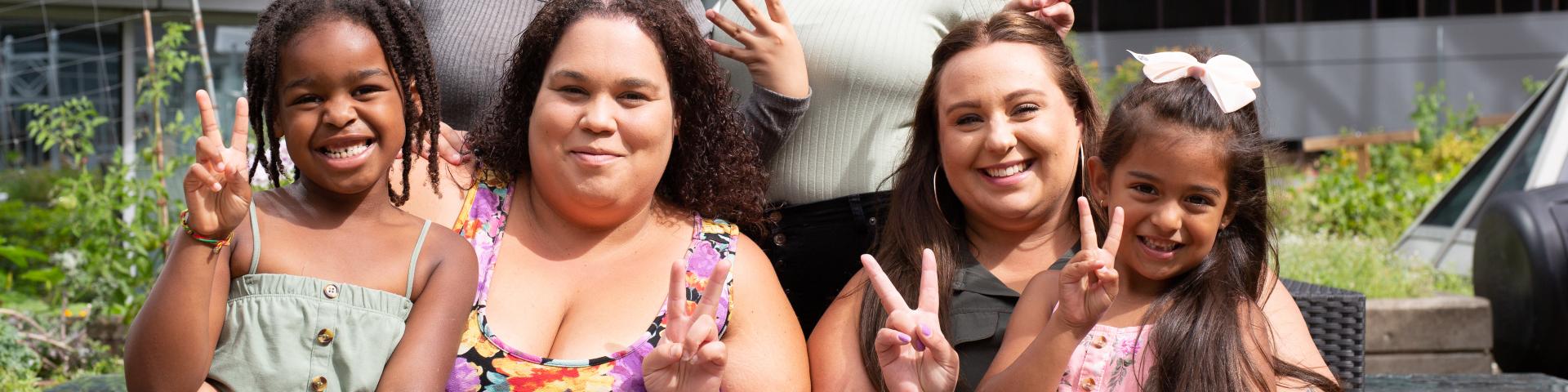 Young girls doing peace signs