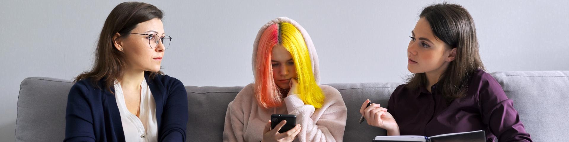 Teen talking with two adults