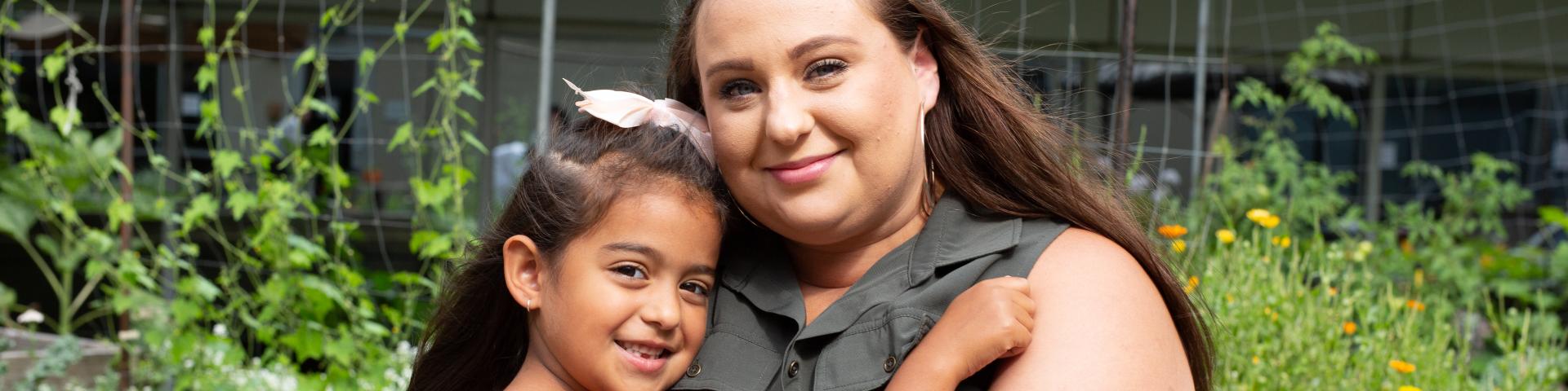 Mother and daughter looking at each other in the eyes, smiling