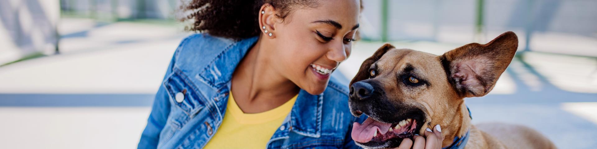 Multiracial Girl Sitting With Dog