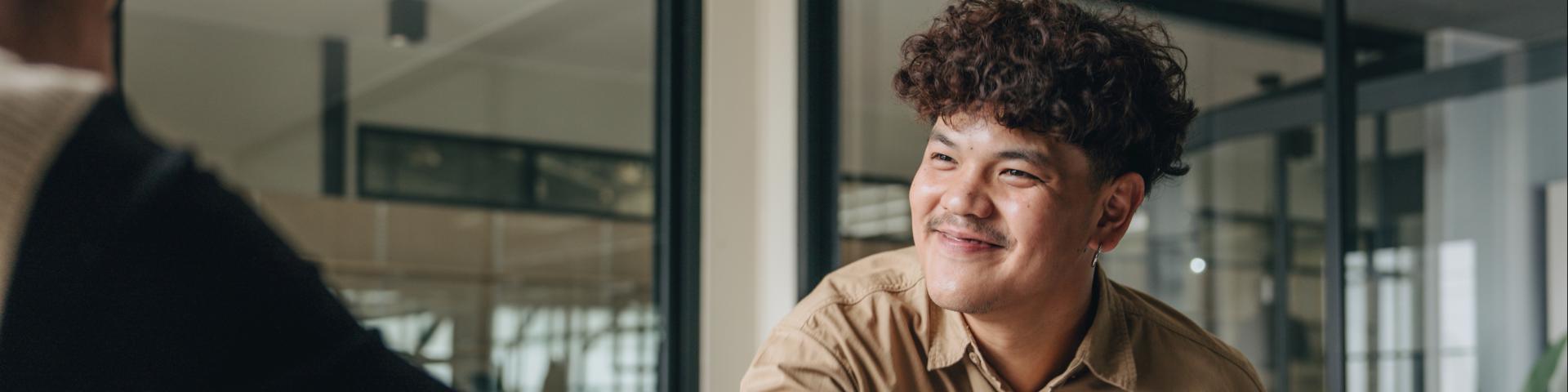 Business people shaking hands in the office. Group of business persons in business meeting.