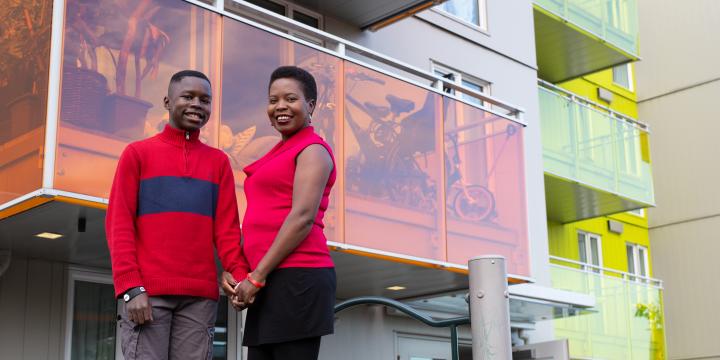Mother and son in the courtyard at YWCA Housing Community, smiling. 