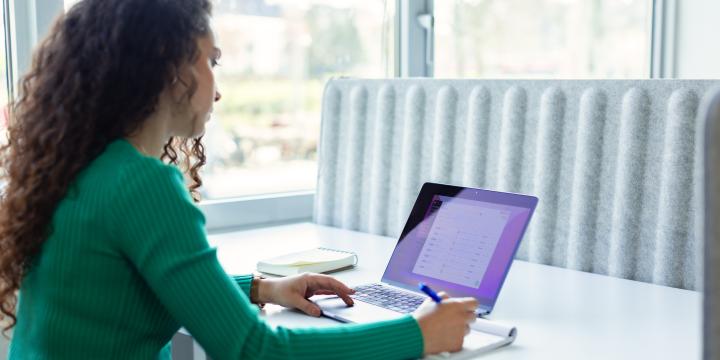 Employee woman taking notes on a project management software