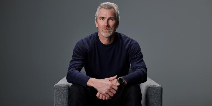 Trevor Linden in a grey chair 