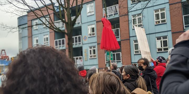 Women's Memorial March 2022 - photo of people marching holding up a red dress