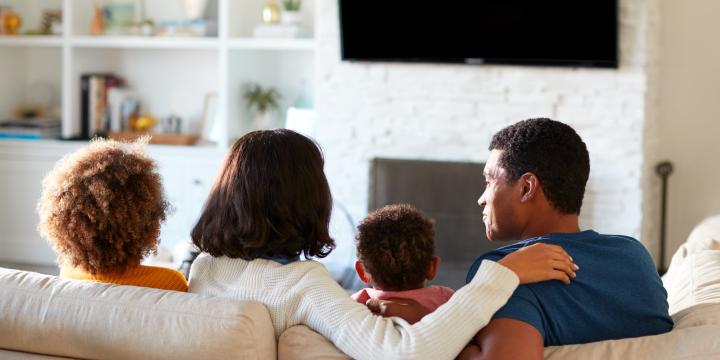 Family watching tv together