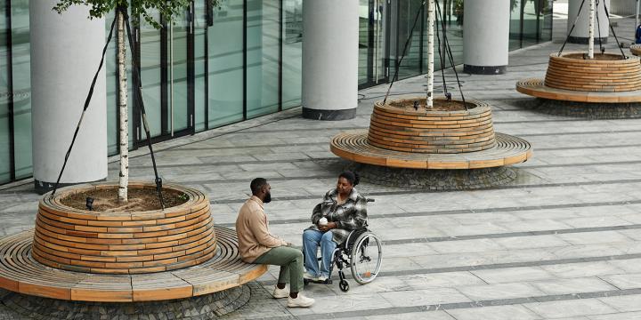 Man and woman talk in city's public space