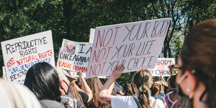 Women holding signs protesting for their abortion rights