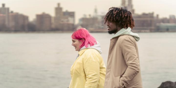 Two young people walking by the sea