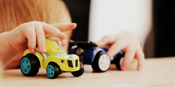 Photo of a small child playing with toys