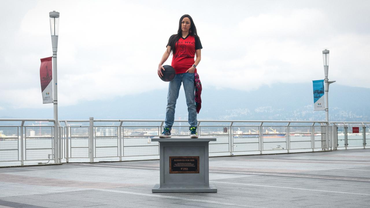 woman posing on statue base