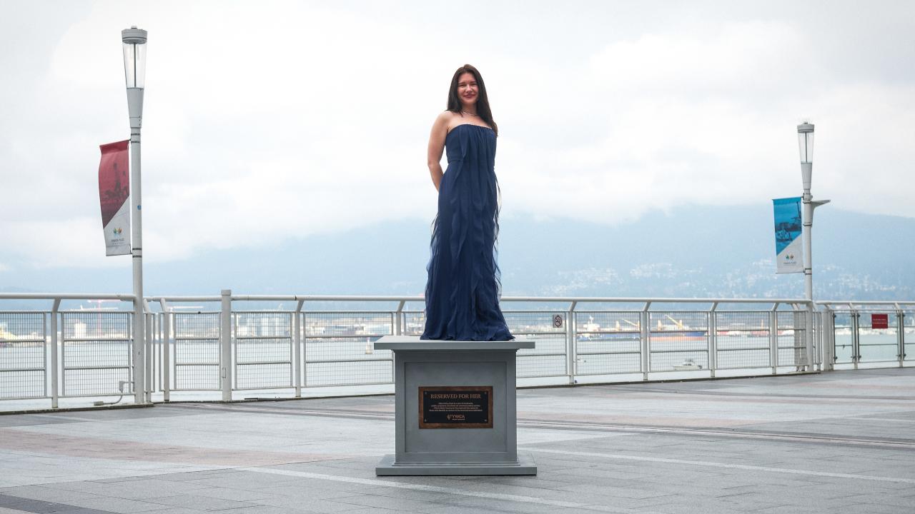 woman posing at statue base