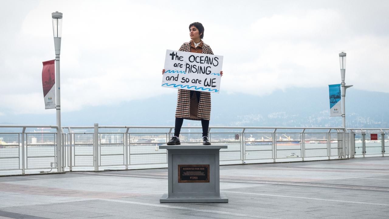 woman posing on statue base