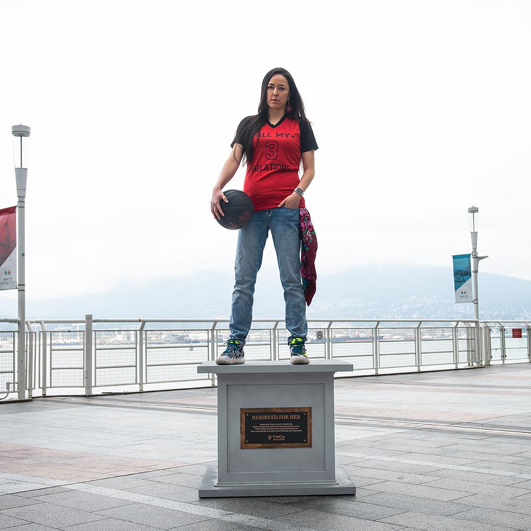 woman posing on statue base