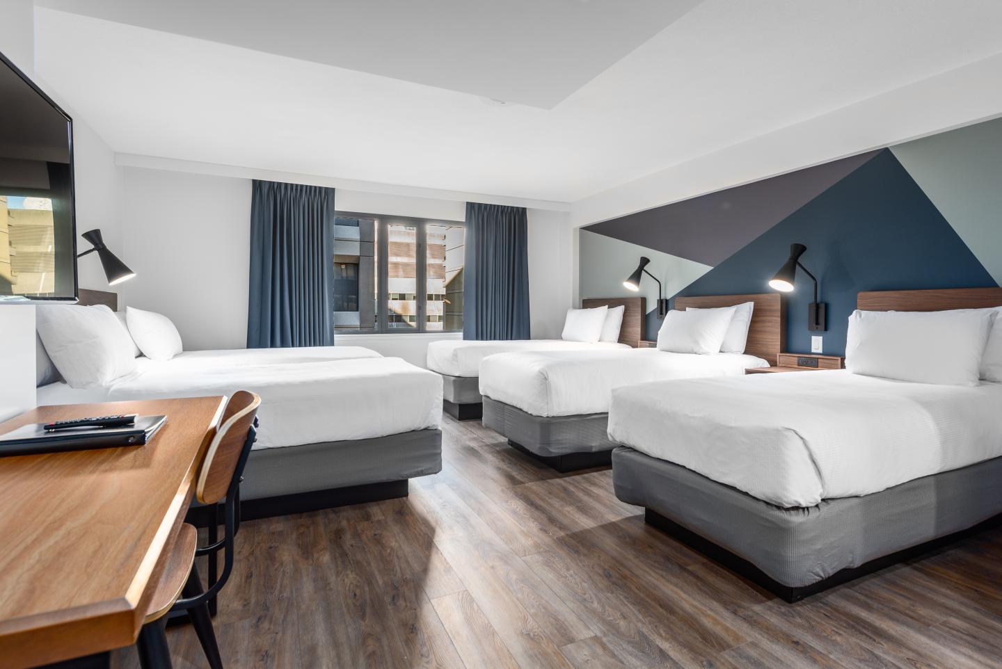 Five single beds in room at Hotel Willo