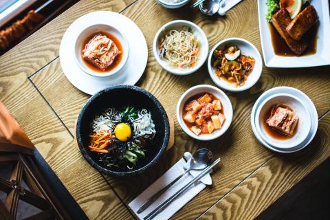 Birds-eye view photo of table with a range of Asian dishes 