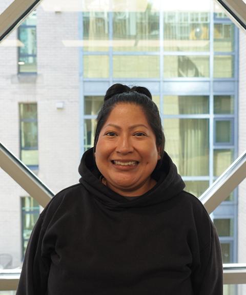 Early childhood educator smiling by window