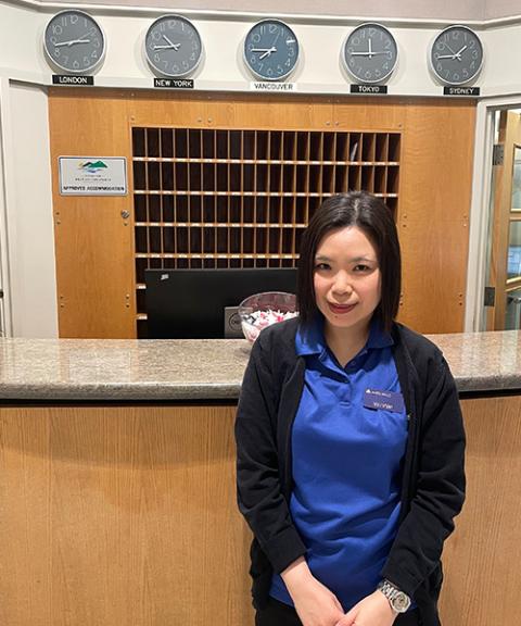 Volunteer standing by hotel reception desk