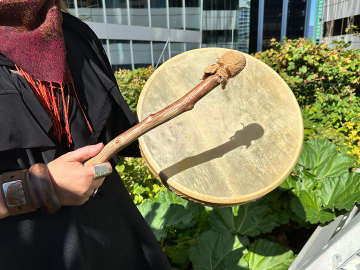Zoom shot of a hand playing an Indigenous drum