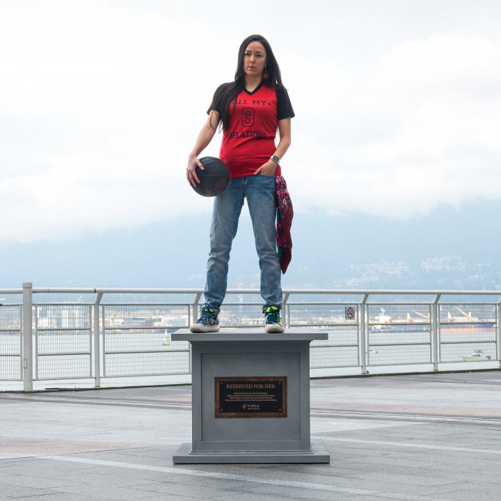 woman posing on statue base