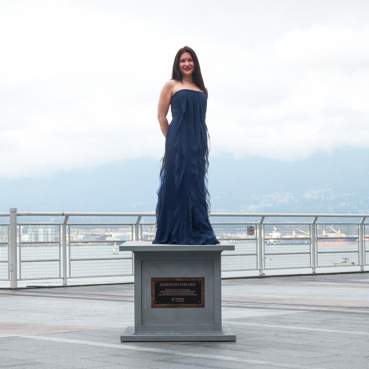 woman posing at statue base