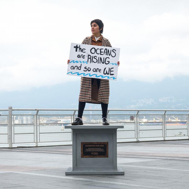 woman posing on statue base