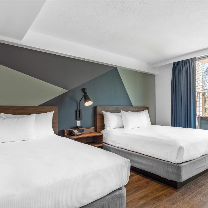 Room with two Queen beds and a private terrace at Hotel Willo in Downtown Vancouver