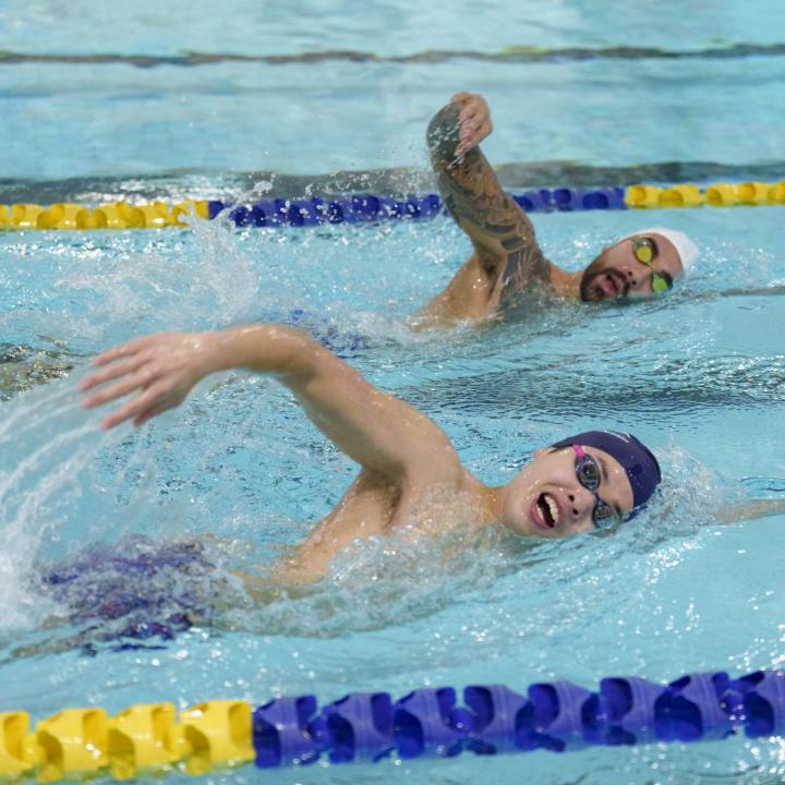 Two swimmers front crawling