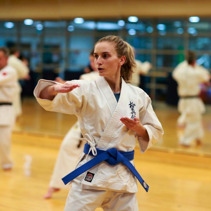 Girl doing karate in a class